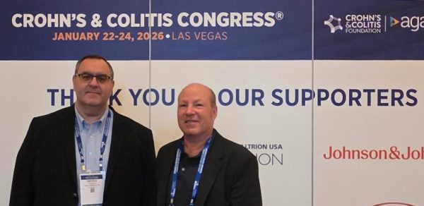Dimitrios Iliopoulos and Allan Pantuck, MD in front o fChron's & Colitis Congress welcome sign
